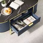 Tavolino da caffè ovale scanalato da 48" con piano in finto marmo, gambe dorate e cassetto portaoggetti nascosto
